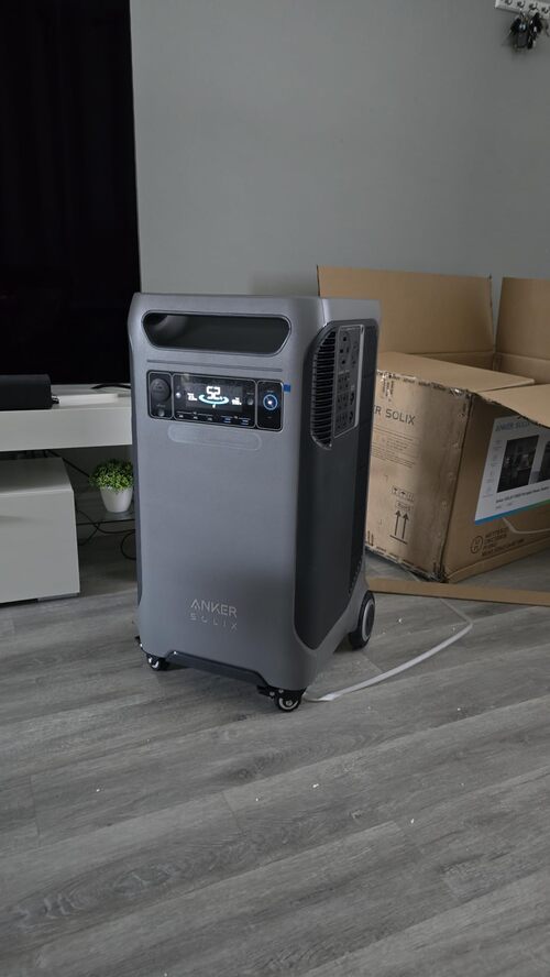 Anker SOLIX F3800 portable power station indoors beside its shipping box