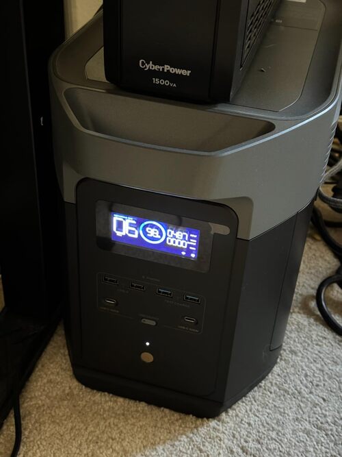 EcoFlow Delta 2 Max powering a CyberPower 1500VA UPS setup with the front display showing charge and runtime