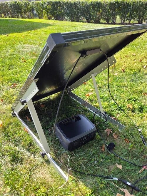 EcoFlow RIVER 3 charging from a solar panel outdoors on grass