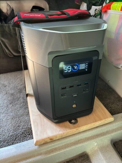 EcoFlow Delta 2 Max portable power station set on a rolling wooden platform inside an RV or camper
