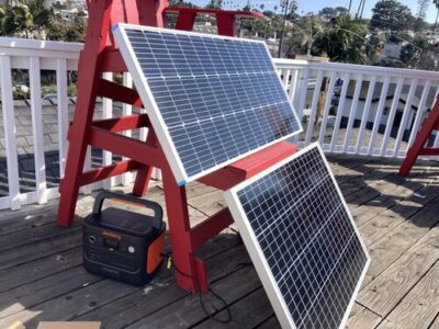 Jackery Explorer 1000 connected to solar panels for outdoor solar charging on a deck