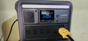 Anker SOLIX C1000 portable power station display showing 98% battery while powering a device