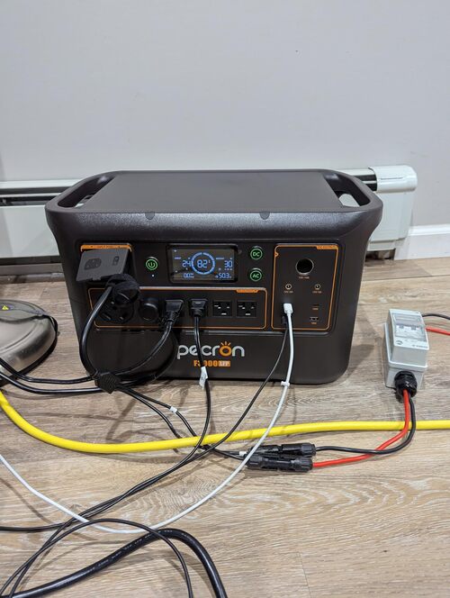 Pecron F3000LFP power station running multiple connected devices indoors with AC and DC cables plugged in