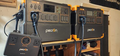 Two Pecron E3600LFP power stations connected with a split phase output box for home backup power