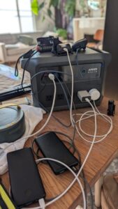 Anker SOLIX power station powering phones, lights, and small devices indoors