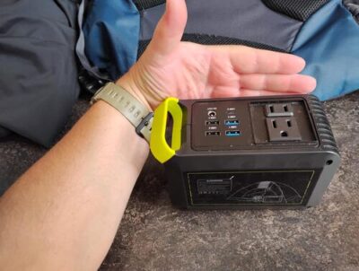 MARBERO M82 portable power station shown next to a hand to demonstrate its compact size for camping and travel