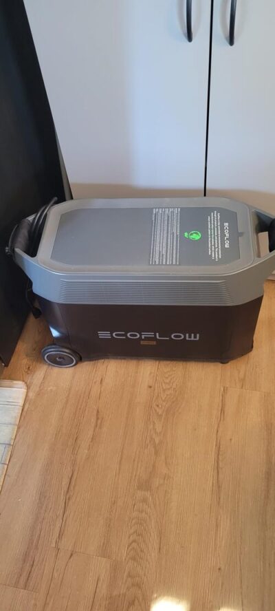 EcoFlow DELTA Pro portable power station on a hardwood floor showing its large wheeled design and top handle