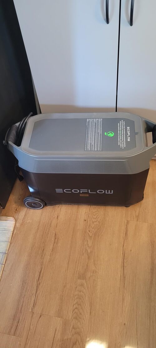 EcoFlow DELTA Pro portable power station on a hardwood floor showing its large wheeled design and top handle