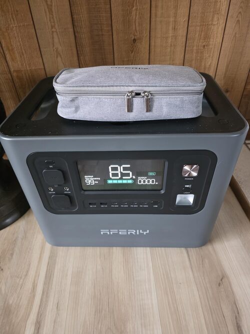 AFERIY P210 display and front ports shown indoors with included gray cable storage pouch on top