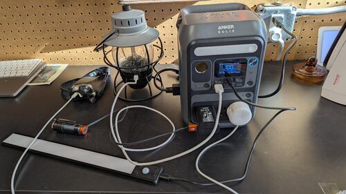 Anker SOLIX C300 charging lights and small electronics on a workbench