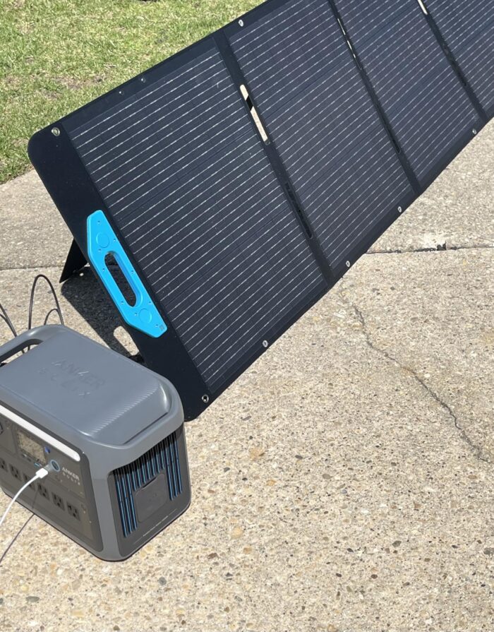 Anker SOLIX C1000 charging from a folding solar panel outdoors in direct sunlight