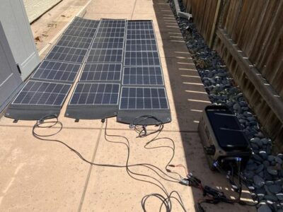 DJI Power 1000 V2 charging from multiple portable solar panels outdoors on a sunny patio