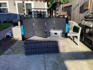 Anker SOLIX C1000 and folding solar panel set up on a backyard patio