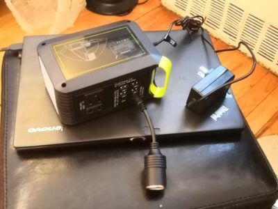 Side view of MARBERO M82 portable power station with wall charger and DC cigarette-lighter output cable connected