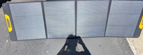 BougeRV FS200W 200W solar panel fully unfolded flat on pavement showing all four accordion sections in direct sun