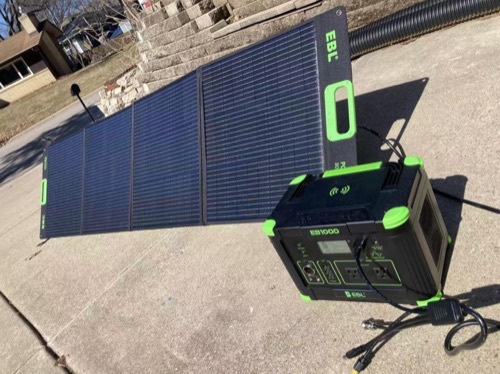 EBL 100W solar panel set up on a sunny driveway charging an EBL 1000 portable power station