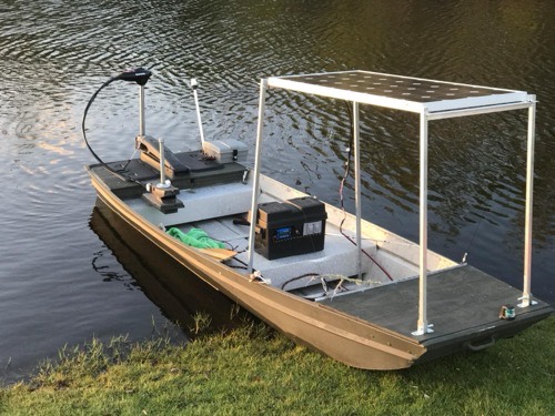 HQST 200W bifacial solar panel mounted as an overhead canopy on an aluminum jon boat with a power station on deck