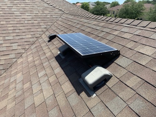 Topsolar 100W monocrystalline solar panel mounted on tilt brackets on a residential shingle roof in full sun