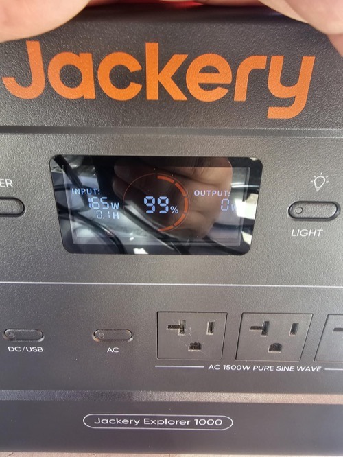 Jackery Explorer 1000 display showing 165W solar input at 99% charge while connected to the TWELSEAVAN 200W panel