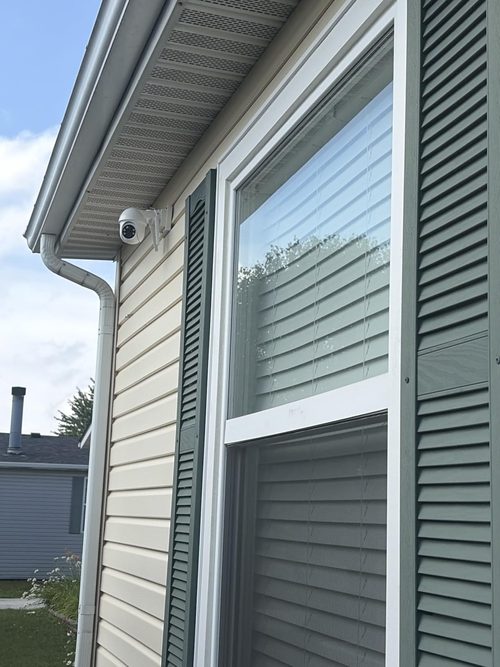 ARCCTV Q01 customer installation beside a window under an eave