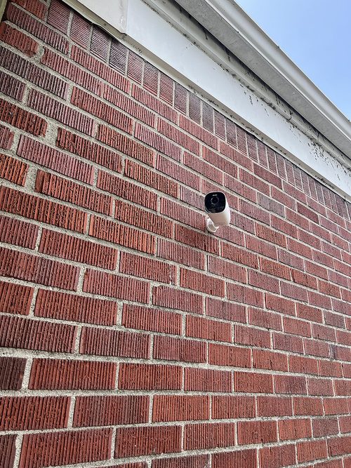 EufyCam S330 installed on a customer's brick wall near the roofline