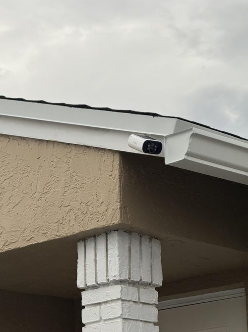 Obligz OZ-S1 customer camera positioned beneath the edge of a roof