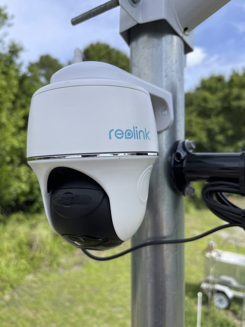 Reolink Argus PT attached to a customer's metal pole with a routed cable