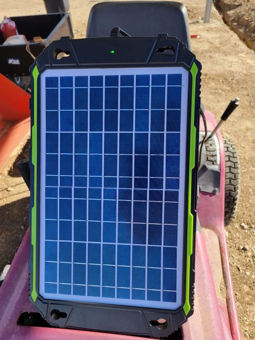 Owner-identified Sun Energise 10W green-trim panel on a lawn tractor with its indicator lit